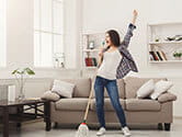 A woman sings in her home's clean living room