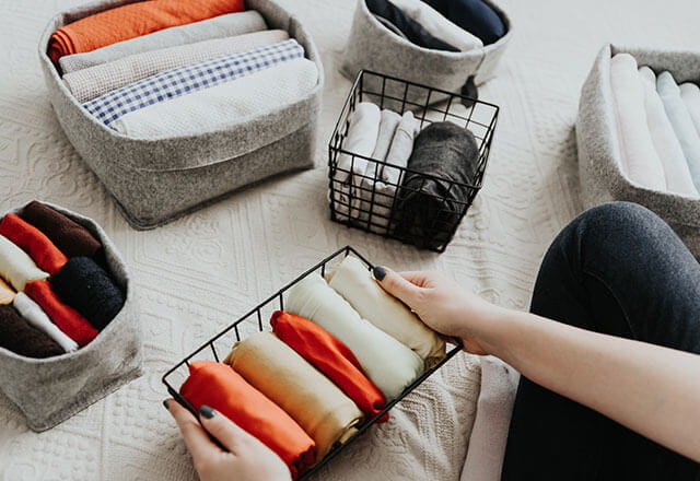 A homeowner folds away their towels and other laundry