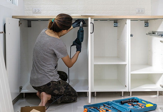 A woman does some DIY work in her home