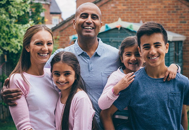 A family smiles for a portrait