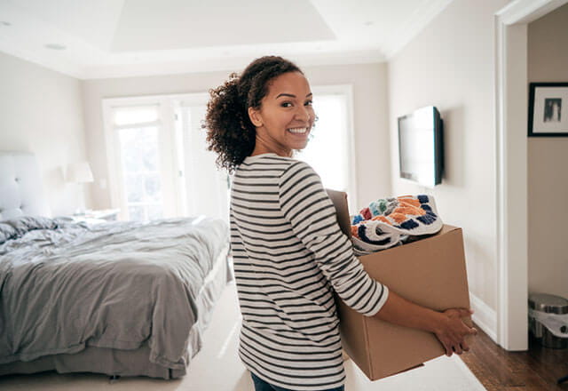 A woman begins organizing stuff in her home