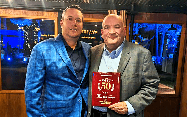 1-800-PACK-RAT representatives accept TBJ Fast 50 award