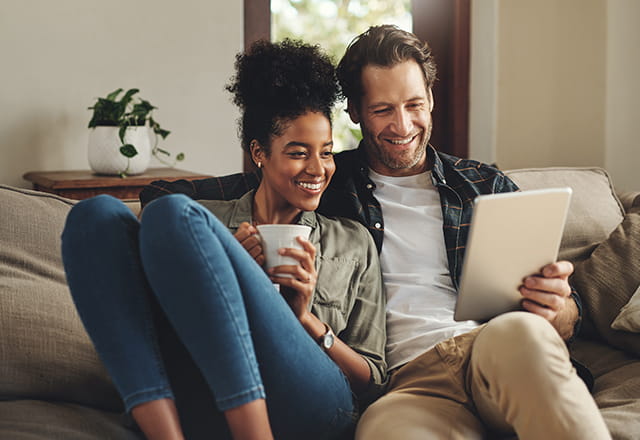 A couple reads off the tablet