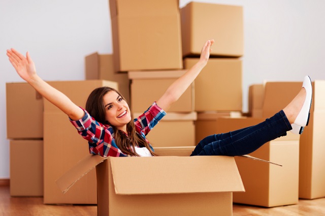 Women smiles as she packs her apartment.