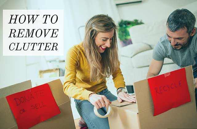 A couple putting together donate, sell, and trash boxes to remove clutter from their home.