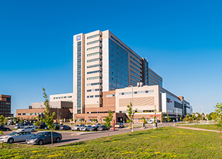 The exterior of a hospital building on a sunny day