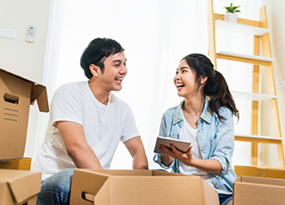 A happy couple looks at their tablet for info