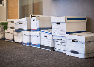 A number of document boxes line an office floor