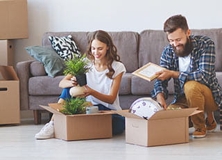 A happy couple unpacks their belongings