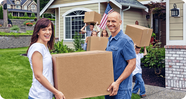 A family unloads boxes into their new home