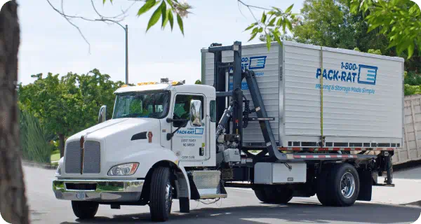 An image of a 1-800-PACK-RAT mini mover truck with a container on the back