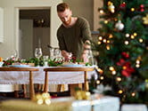 A man cleans and sets up the table for a holiday meal