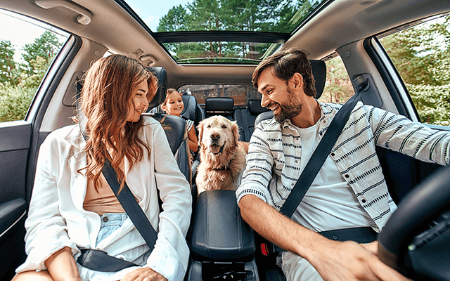 A family is in their car preparing to embark on a cross-country trip