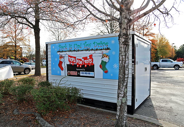 A 1-800-PACK-RAT portable storage container being used for a Toys for Tots toy drive