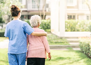 A medical professional assists an elderly patient