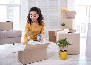 A college student packs boxes with her stuff