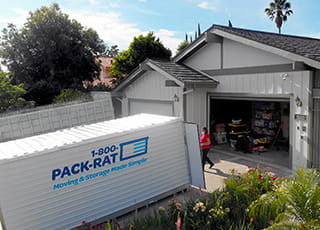 Customers load their belongings into a 1-800-PACK-RAT portable storage container