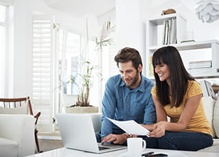 A couple does research on their laptop