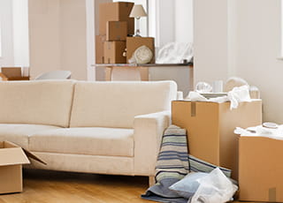 Boxes and other items sit ready to be packed out in a home living room