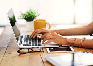 A person uses their laptop in their home