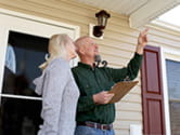 A homeowner speaks with a home inspector doing a report on her home