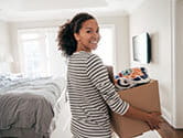 A woman begins organizing stuff in her home