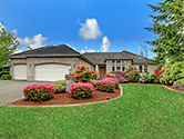 Exterior shot of a well manicured front yard of an upper middle class home