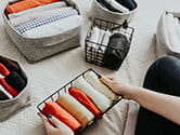 A homeowner folds away their towels and other laundry