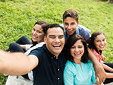 A happy family takes a selfie in their yard