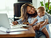 A mother plays with her baby while she gets work done