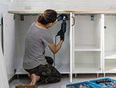 A woman does some DIY work in her home