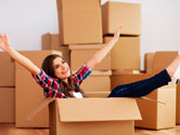 Women smiles as she packs her apartment.