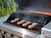 A grill with burgers getting cooked