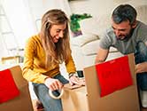 A family removes clutter by separating their items into boxes to help organize.