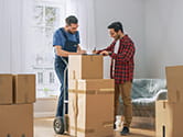 A homeowner signs paperwork with a professional laborer