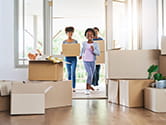 A family moves boxes into their new home